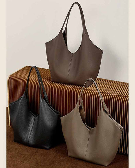 Three leather handbags in black, coffee, and gray